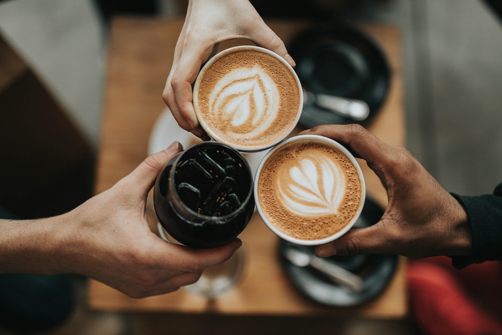 Friends doing a toast with coffee drinks